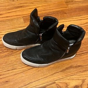 Steve Madden black wedge sneaker with zippers on both sides and white soles